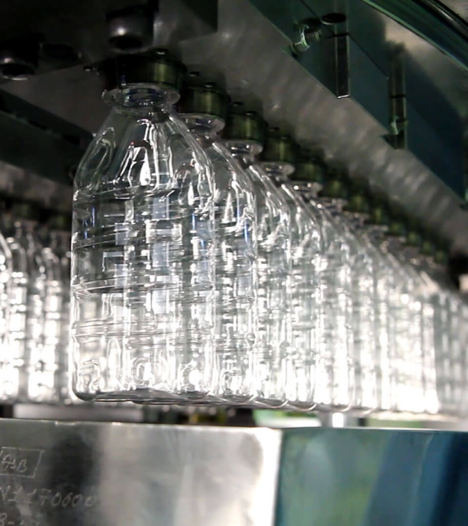Image of plastic water bottles under process.